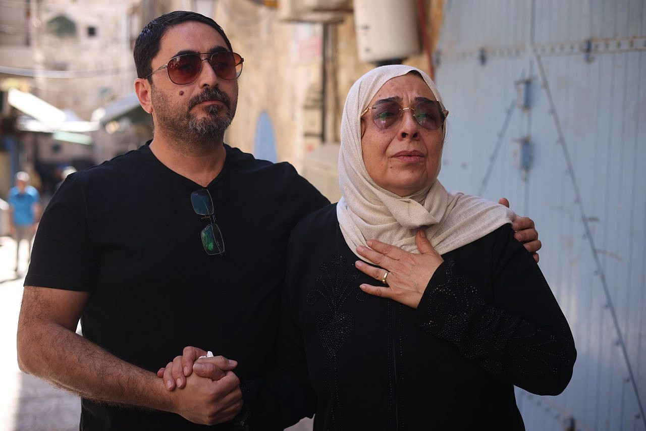 Nora Sub Laban and her son, Ahmad, cry outside their home in Jerusalem’s Old City after they were forcibly expelled by police as Israeli settlers took over their home, July 11, 2023. (Oren Ziv)