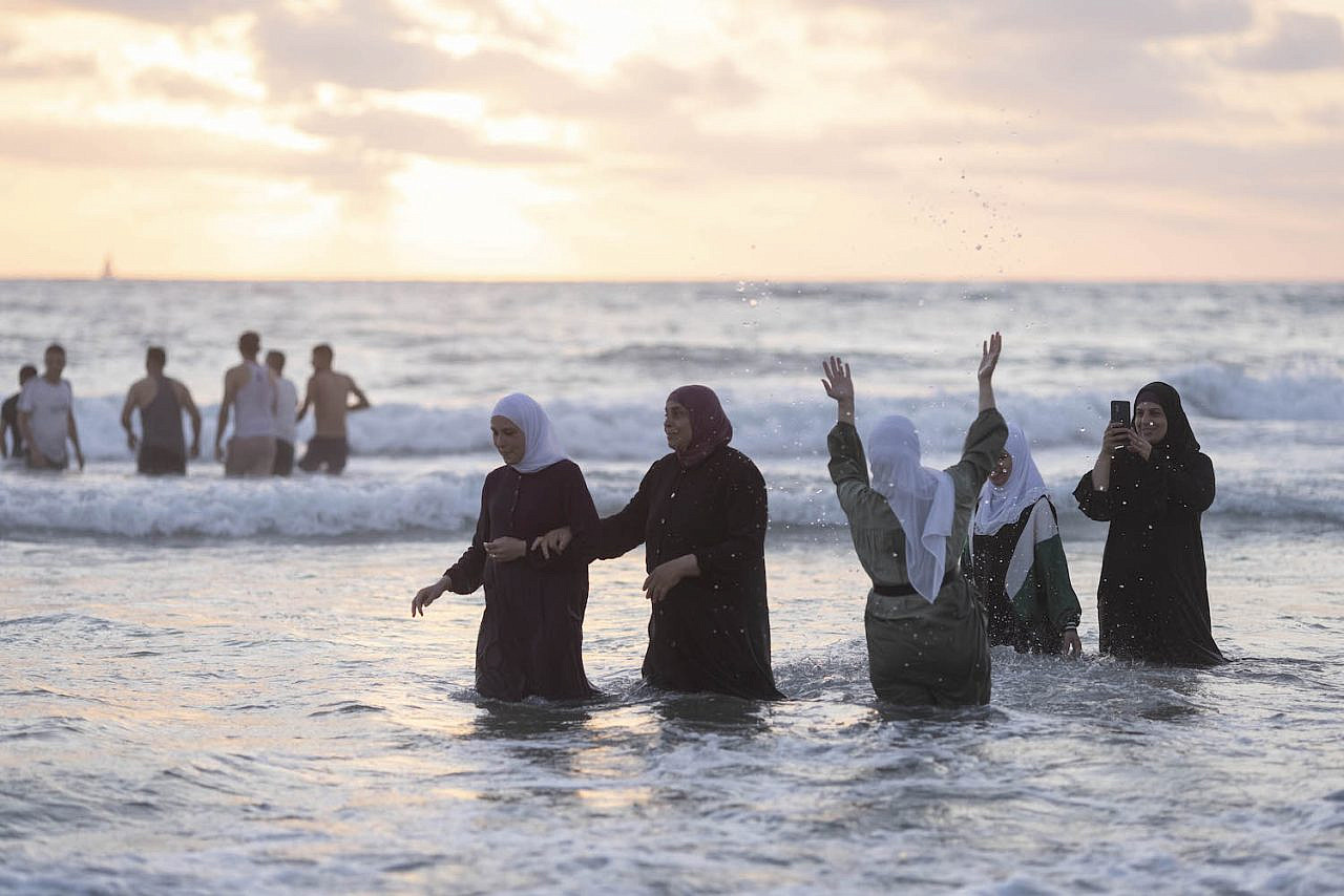 Palestinians, many of them from the West Bank, enjoy a day at the beach in Tel Aviv, during the second day of the Eid al-Adha holiday, June 29, 2023. (Oren Ziv)