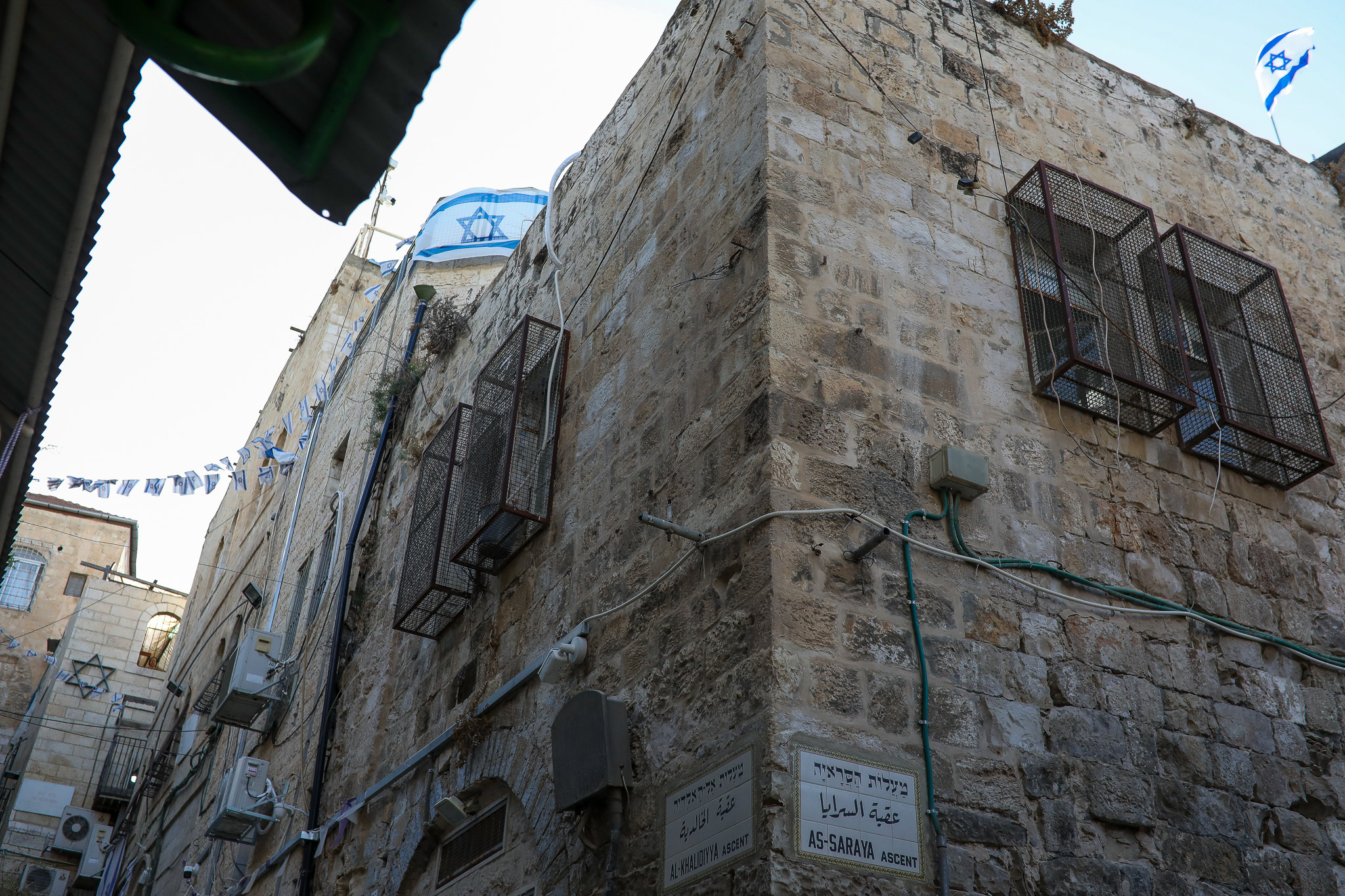 An Israeli flag hangs outside the home of the Ghaith Sub-Laban family in the Old City of Jerusalem, after Jewish settlers took over the property, July 11, 2023. (Yahel Gazit)