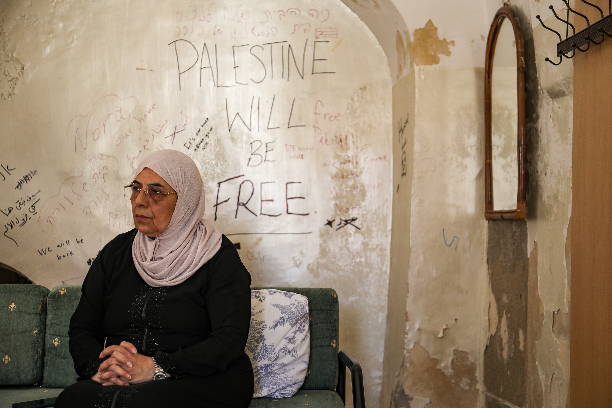 Nora Ghaith Sub-Laban sitting in her home in the Old City of Jerusalem, before she and her family were expelled to make way for Jewish settlers, June 12, 2023. (Yahel Gazit)