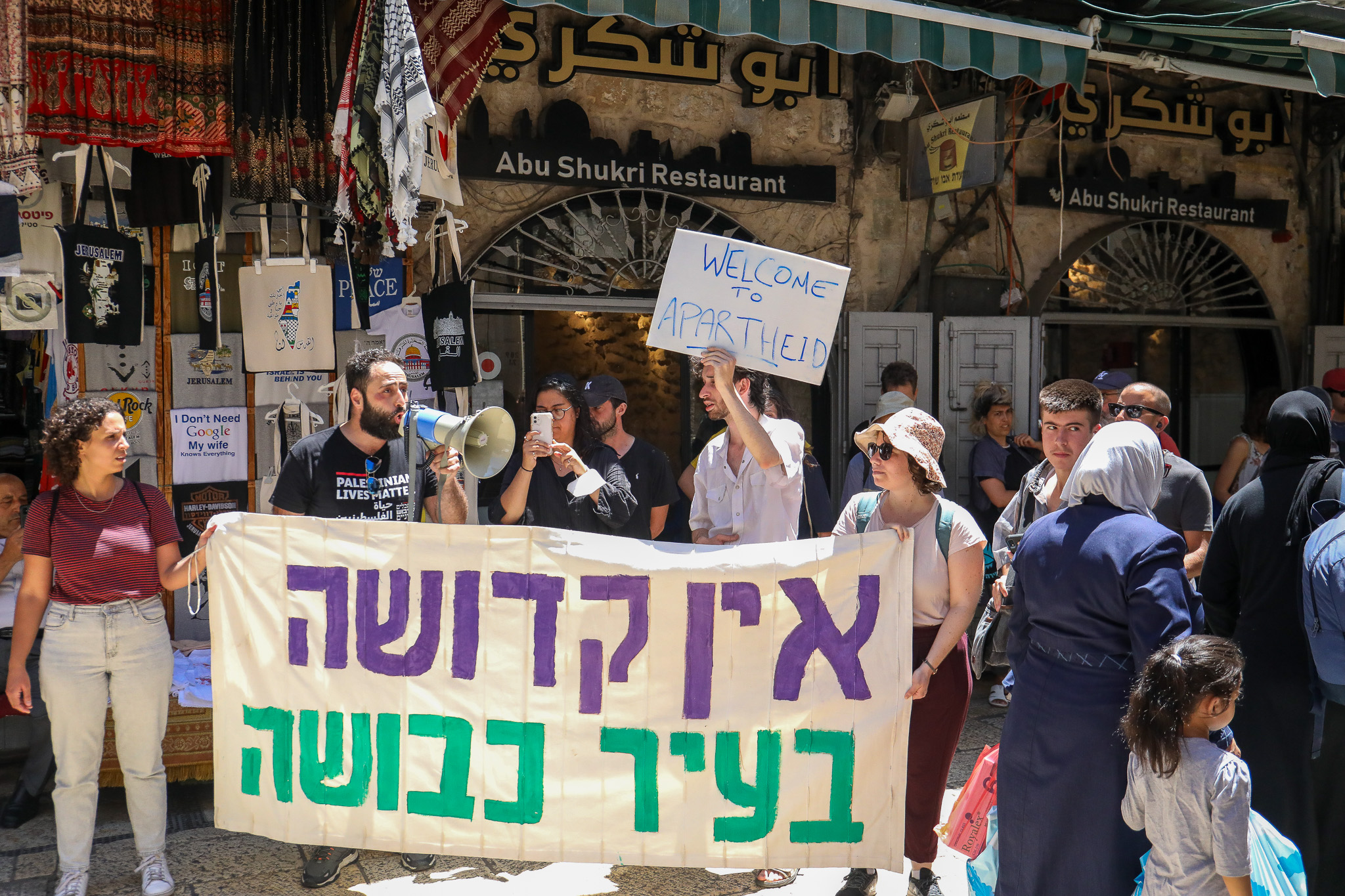 Rafat Sub-Laban and activists protesting outside his family's home in the Old City of Jerusalem, after they were expelled by Israeli police to make way for Jewish settlers, July 11, 2023. (Yahel Gazit)