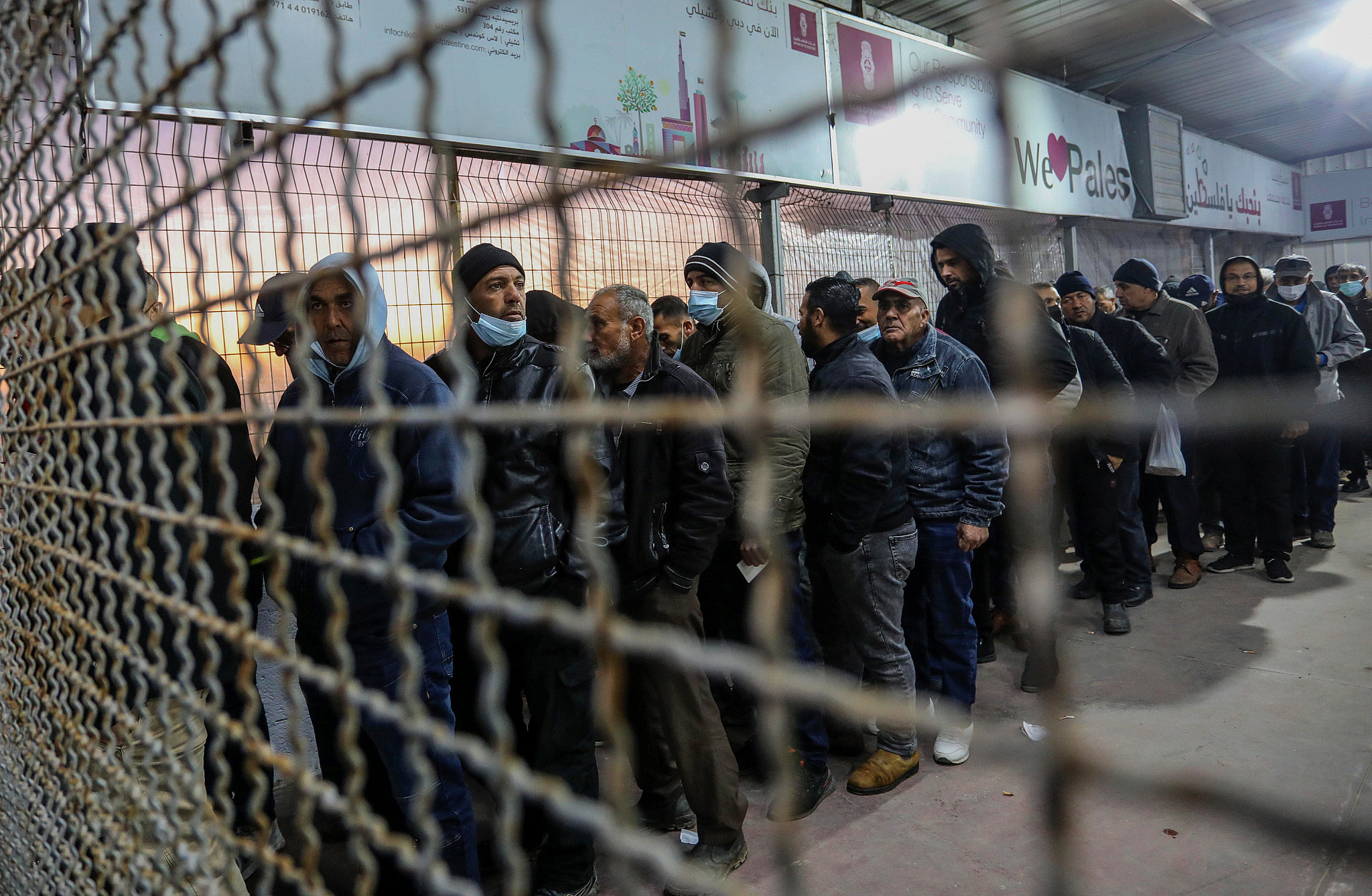 Palestinian workers at the Erez crossing in Beit Hanoun in the northern Gaza Strip, waiting to enter Israel for work, March 13, 2022. (Attia Muhammed/Flash90 )