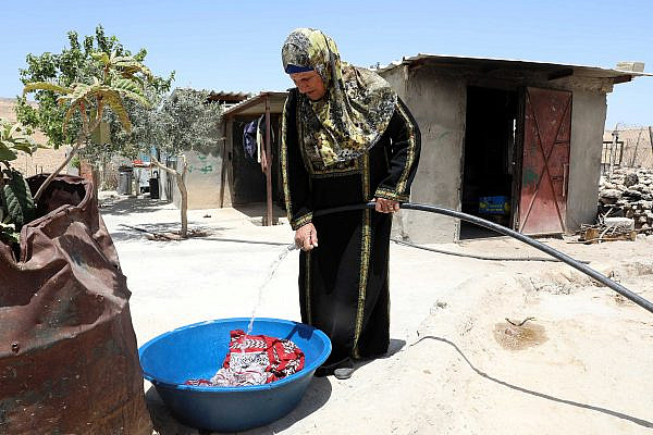 Palestinian woman using a water pipe in Masafer Yatta, in the West Bank, May 10, 2022. (Wisam Hashlamoun/Flash90)
