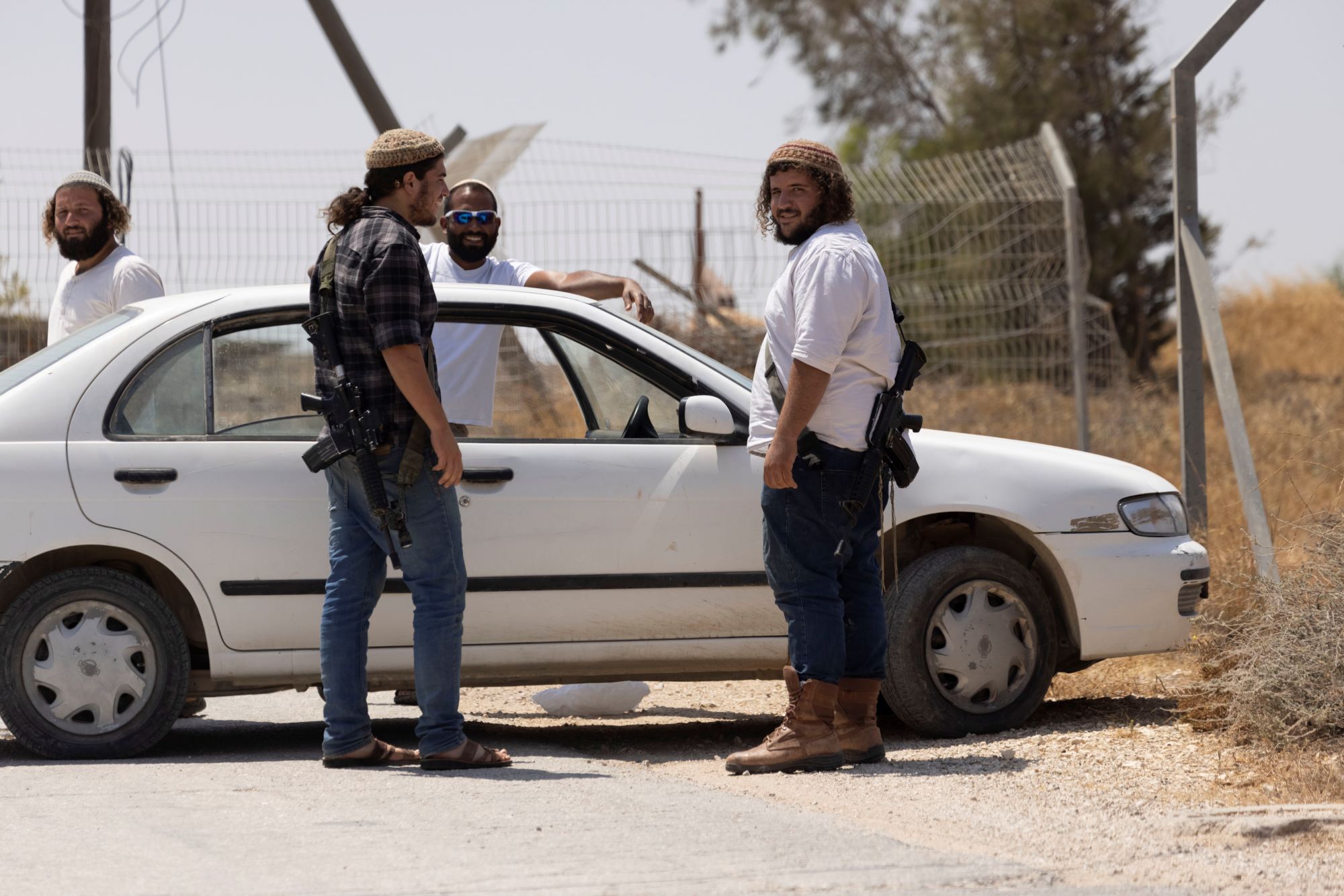 Armed Israeli settlers near the outpost of Malachei HaShalom, West Bank. (Oren Ziv)