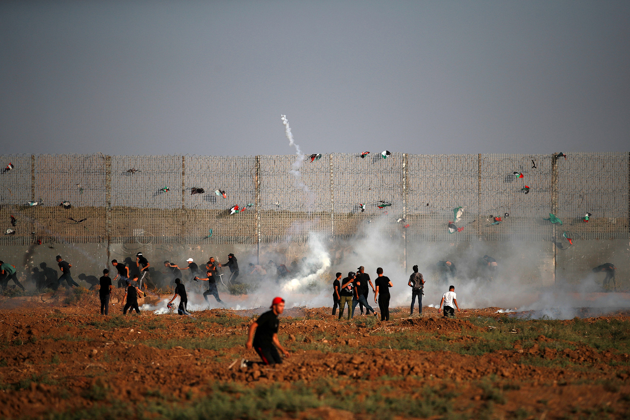 Palestinians confront Israeli forces along the barrier imprisoning the Gaza Strip, east of Gaza City, September 22, 2023. (Mohammed Zaanoun/Activestills)