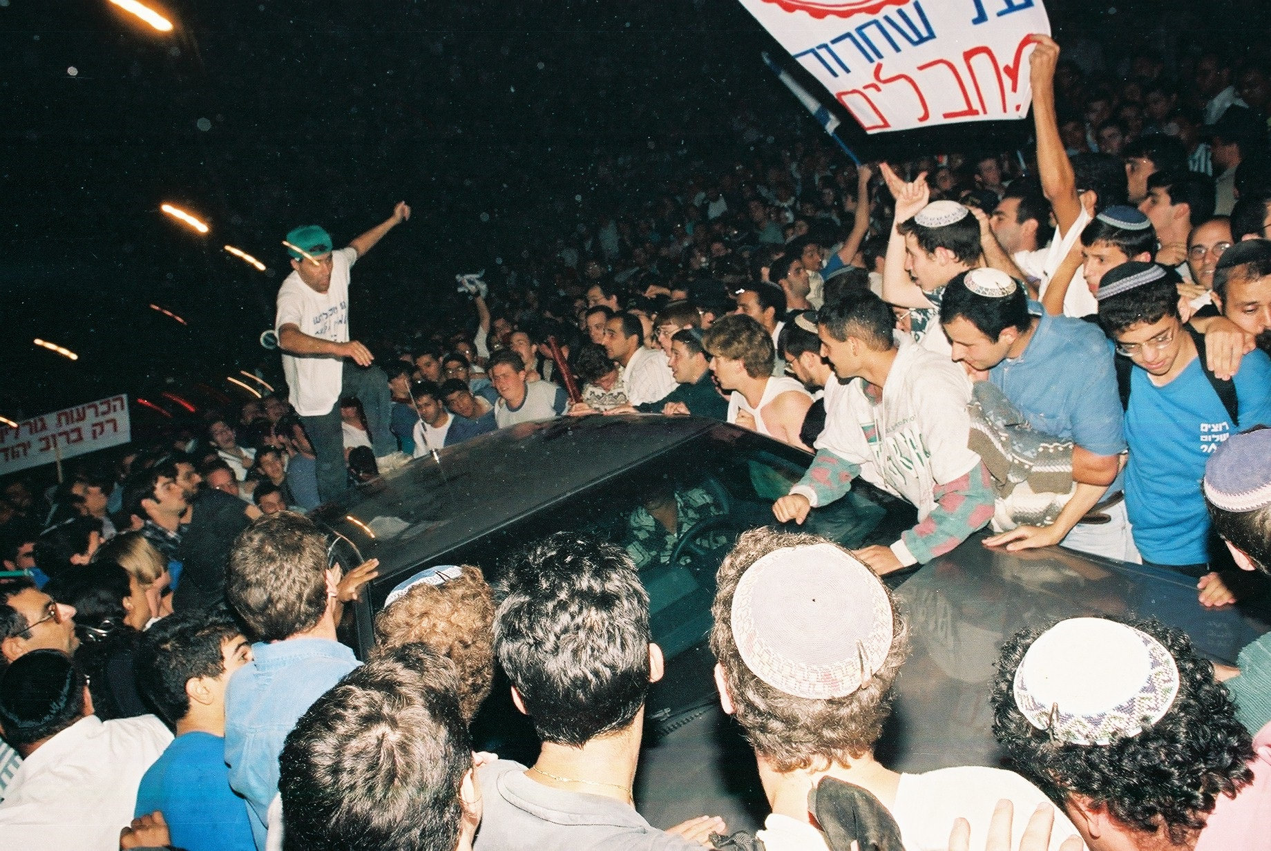 Right-wing demonstrators pound on the vehicle of Israeli Prime Minister Yitzhak Rabin during a protest against his policies, Jerusalem, October 5, 1995. (Flash90)