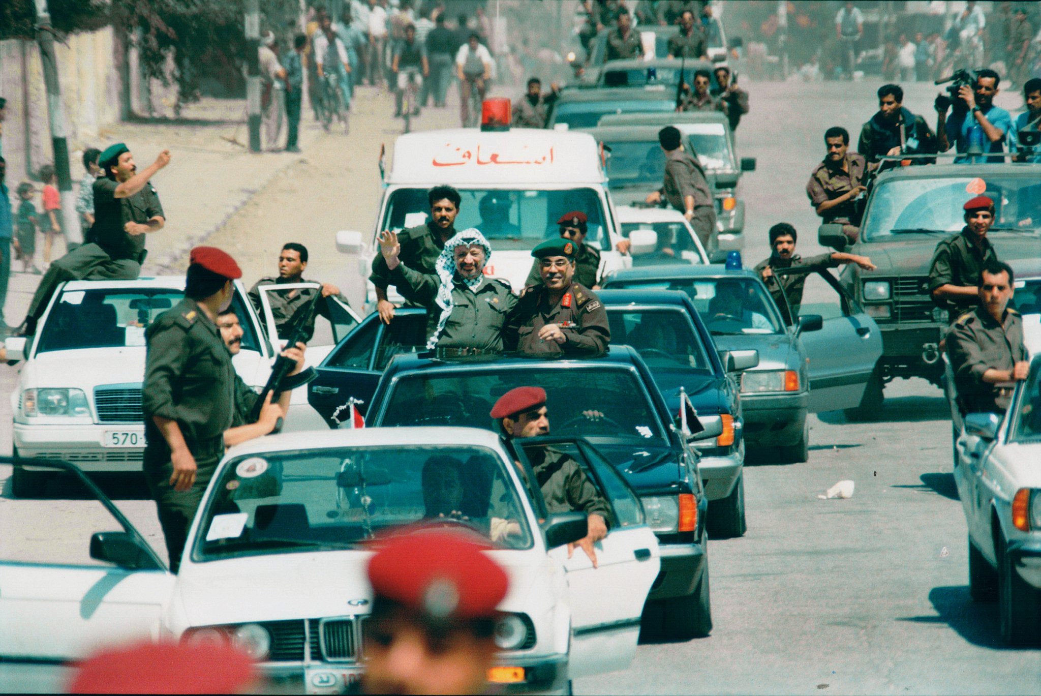 Palestinian President Yasser Arafat with a police convoy arriving in Gaza, 1994. (Moshe Shai/Flash90)