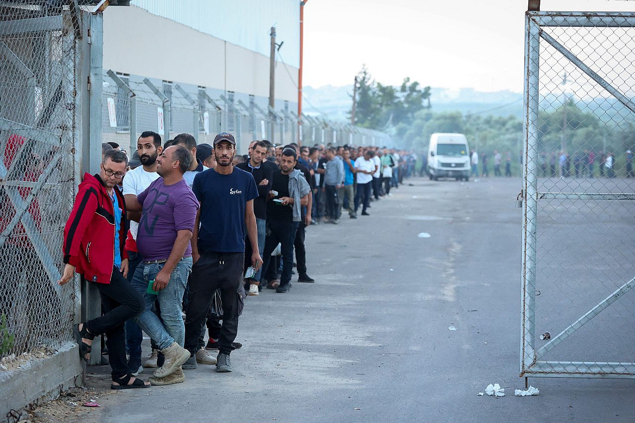 Palestinian workers stand in line at the reopened Erez crossing to Israel, after Israel ends a ban on workers from Gaza, September 28, 2023. (Atia Mohammed/Flash90)