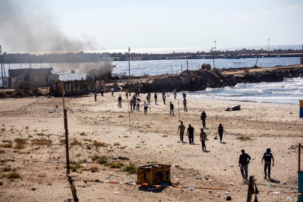 Smoke rises from a beach in Gaza after Israeli drone strikes killed 4 children from the Bakr family: Ahed Atef Bakr, 9, Zakaria Ahed Subhi Bakr, 10, Mohammed Ramez Izzat Bakr, 11, and Ismail Mohammed Subhi Bakr, 9, July 16, 2014. (Anne Paq/Activestills)