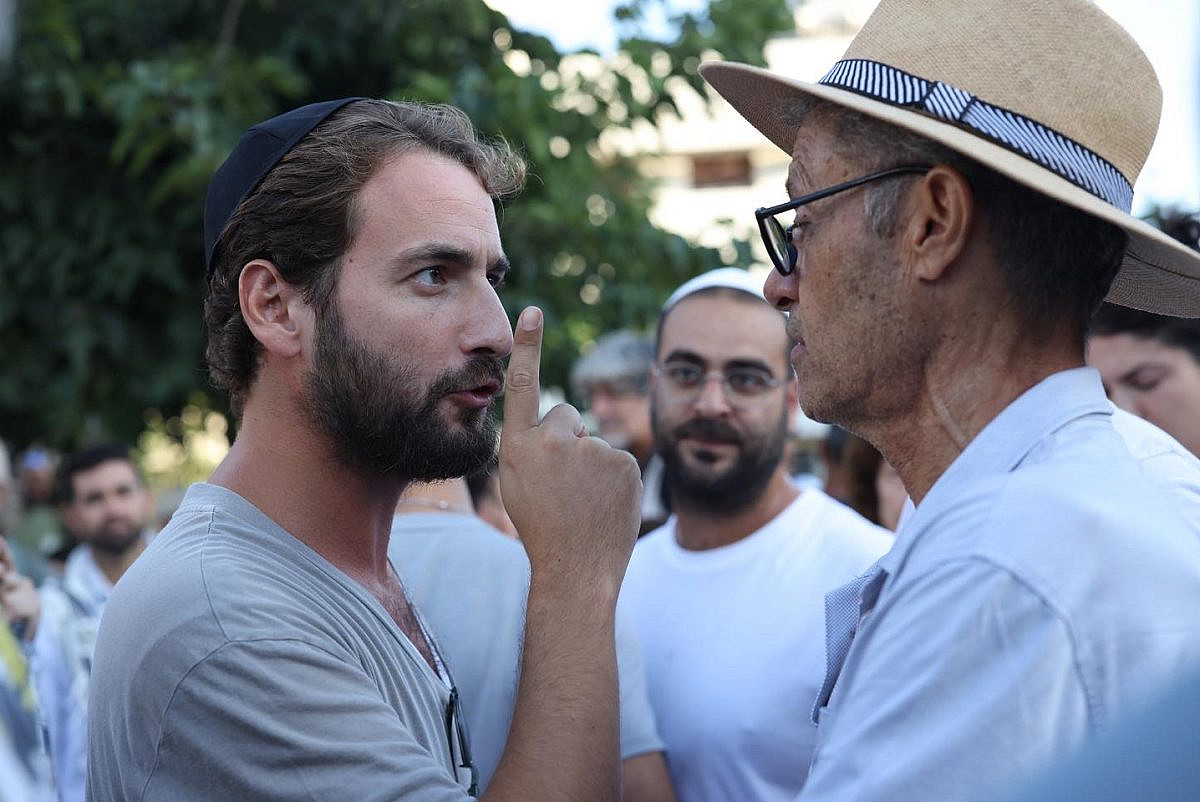 Protesters argue with worshippers affiliated with the Rosh Yehudi organization over gender-segregated prayer on Yom Kippur in Dizengoff Square, Tel Aviv, September 25, 2023. (Oren Ziv)