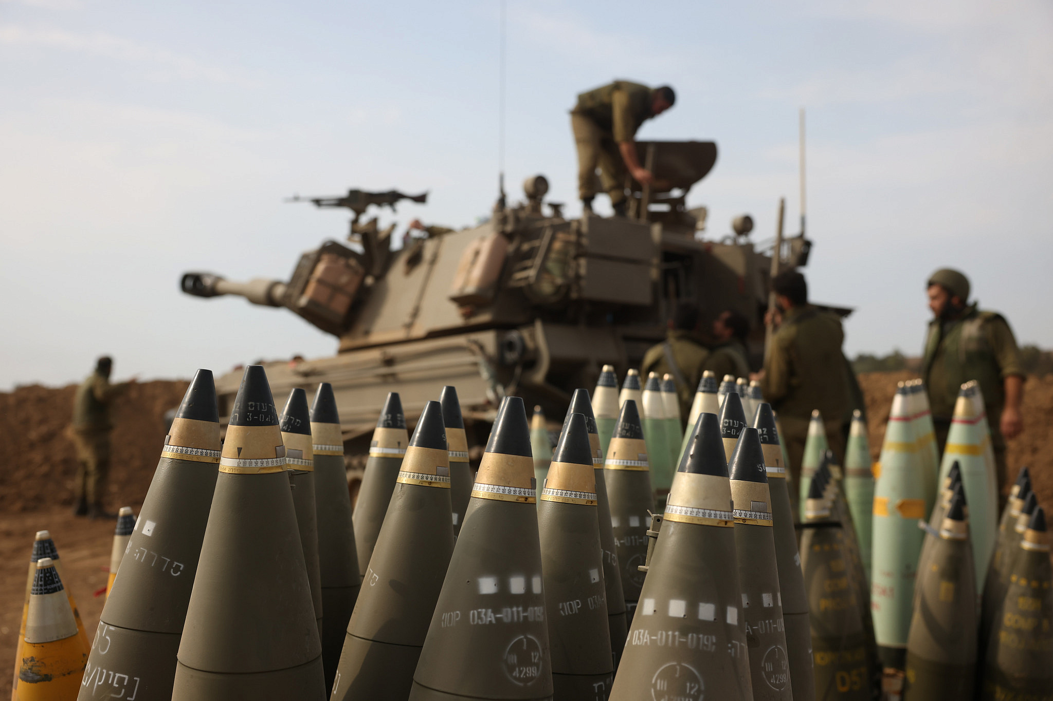 Israeli troops with munitions at a staging area outside Gaza, October 11, 2023. (Oren Ziv)