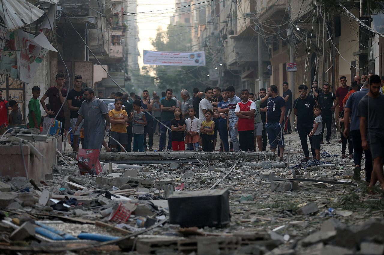 Palestinians inspect the damage following an Israeli airstrike that killed five people in central Gaza City. (Mohammed Zaanoun)