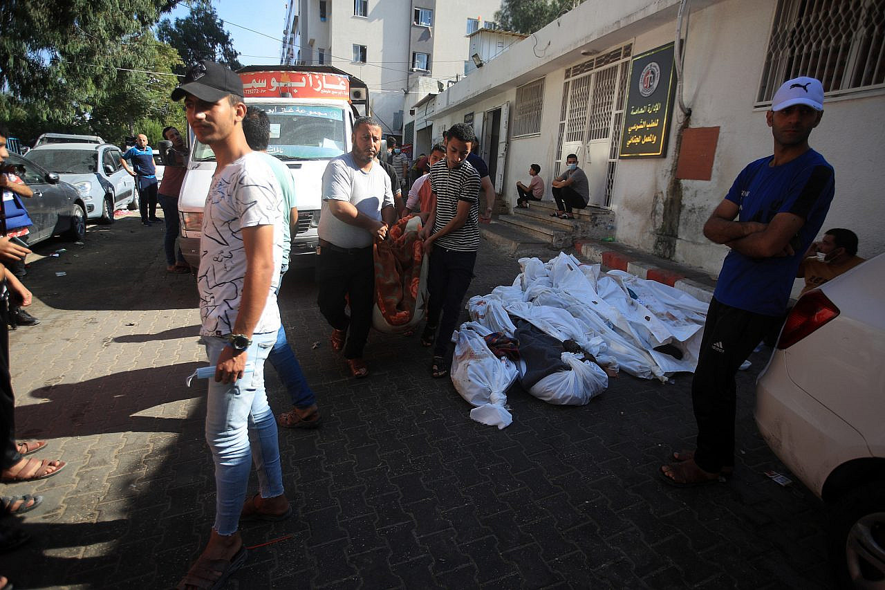 Palestinians' bodies are removed in the aftermath of the explosion at Al-Ahli Arab Hospital, Gaza City, October 18, 2023. (Mohammed Zaanoun)