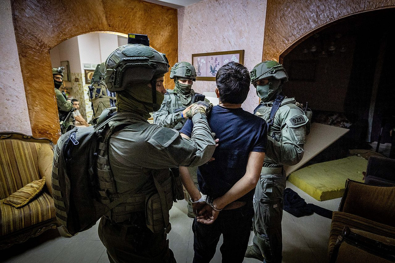 Members of the Jerusalem Yamas special forces counter-terrorist unit arrest a Palestinian accused of wounding Israeli Border Police officers and planning a terror attack, Abu Dis, south of Jerusalem, June 7, 2023. (Nati Shohat/Flash90)
