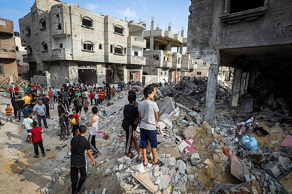 Palestinians inspect the rubble of a building destroyed by Israeli warplanes, in Rafah, in the southern Gaza Strip, October 8, 2023. (Abed Rahim Khatib/Flash90)
