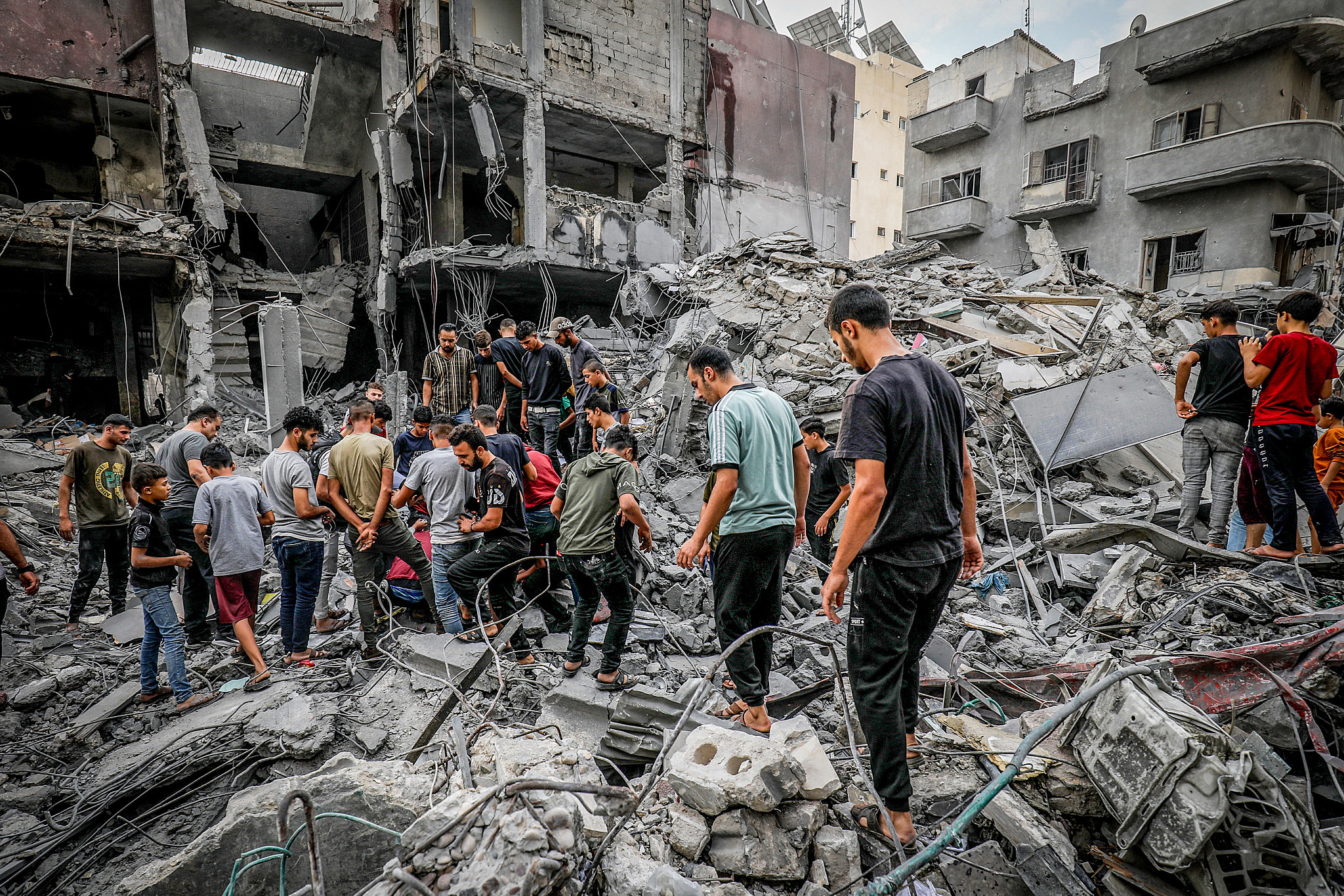 Palestinians search the Khan Younis municipality building after an Israeli airstrike, Gaza Strip, October 10 2023. (Abed Rahim Khatib/Flash90)