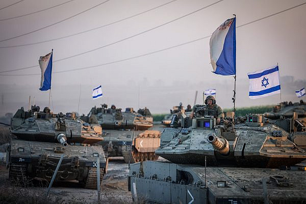 A convoy of Israeli tanks at sunset near the southern Israeli border with Gaza, October 12, 2023. (Chaim Goldberg/Flash90)