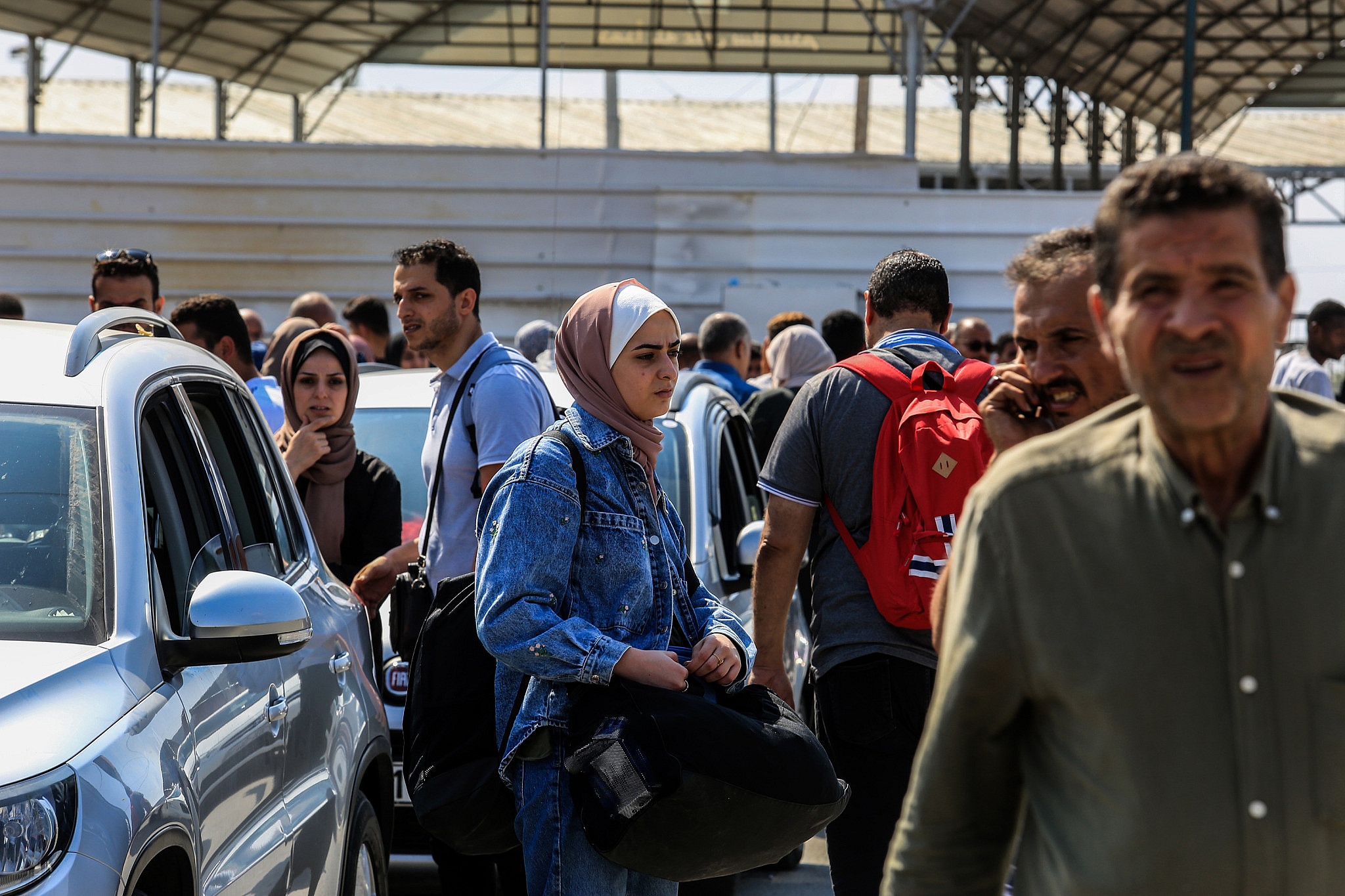 Palestinians who have fled from their homes wait at the Rafah crossing to Egypt in the southern Gaza Strip, October 14, 2023. (Abed Rahim Khatib/Flash90)