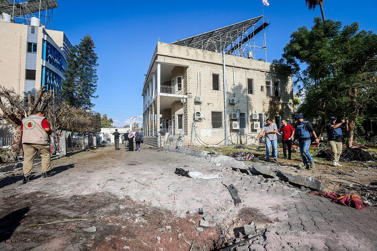 Palestinians inspect the damage caused from an explosion at the Al-Ahli Arab Hospital, Gaza City, October 18, 2023. (Atia Mohammed/Flash90)