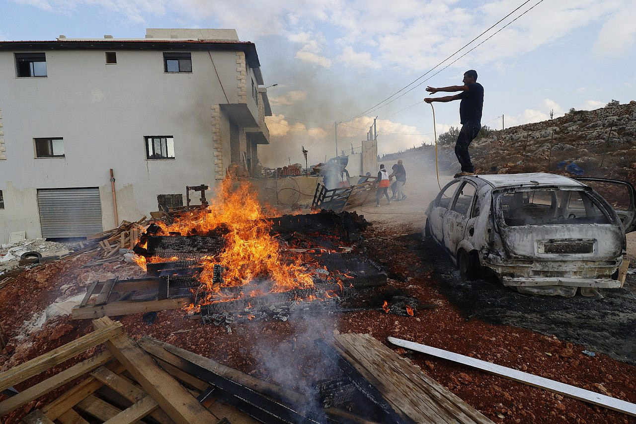 A fire burns following an Israeli settler attack that killed four Palestinians in Qusra village, near the northern West Bank city of Nablus, October 11, 2023. (Wahaj Bani Moufleh/Activestills)