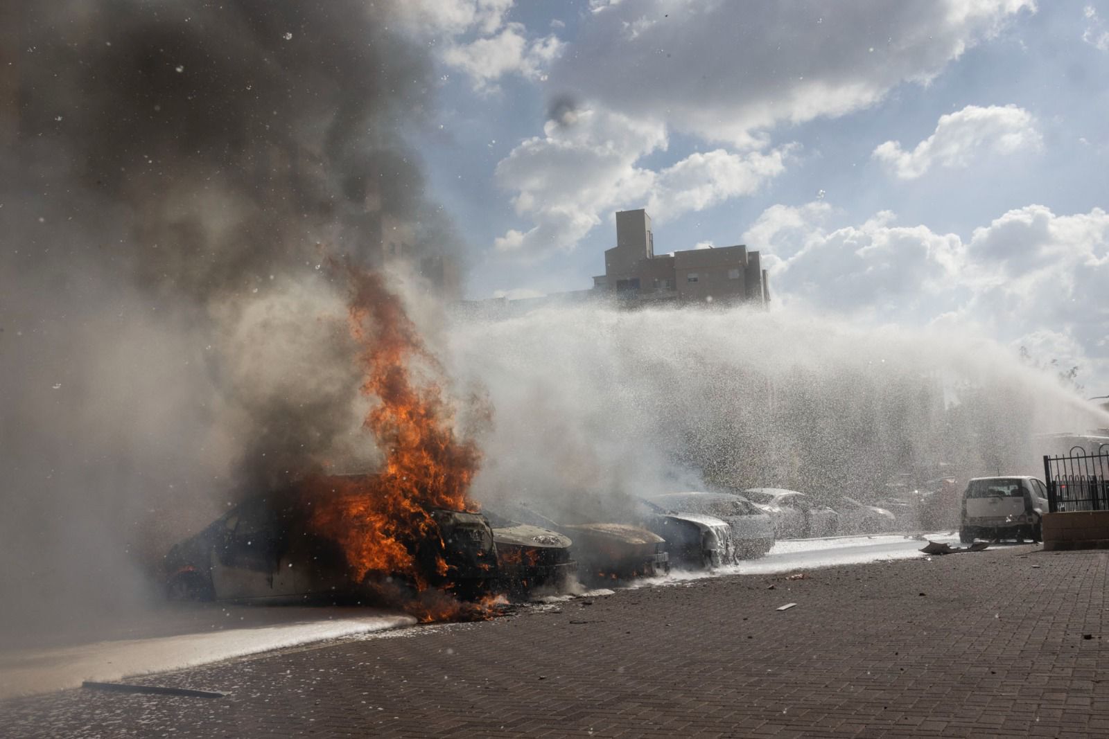 Cars ablaze in Ashkelon during a Hamas incursion, October 7, 2023. (Oren Ziv)