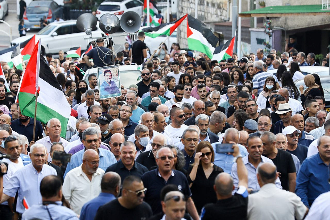 Palestinian citizens of Israel march as they take part in protest marking the 21st anniversary of the October 2000 riots, in which Israeli police killed 13 Palestinian citizens, Sakhnin, October 2, 2021. (Alon Nadav/Flash90)