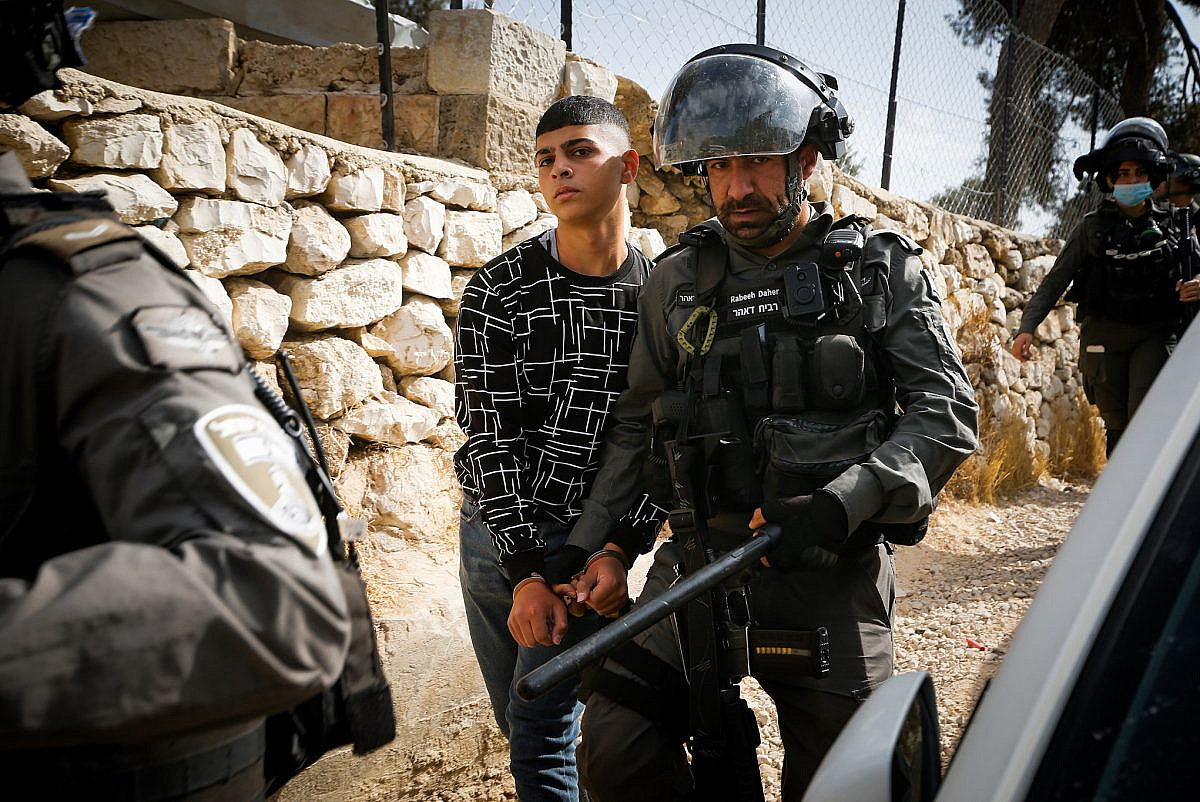 Police arrest a Palestinian youth during a protest against a construction site for a new public park near Muslim graves, outside Jerusalem's Old City, October 29, 2021. (Jamal Awad/Flash90)