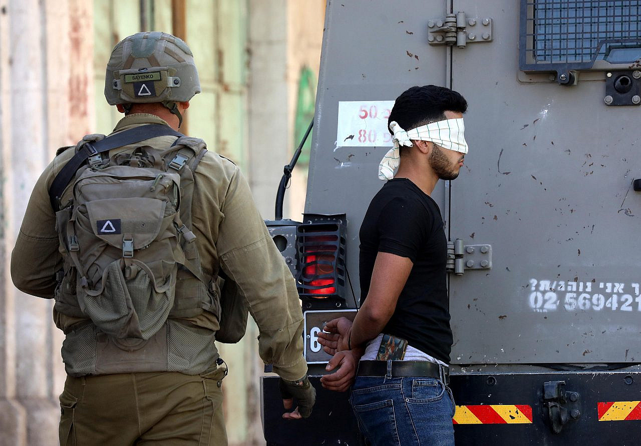 Israeli soldiers arrest a Palestinian youth during confrontations between Palestinian youths and Israeli soldiers in the occupied West Bank city of Hebron, September 9, 2022. (Wisam Hashlamoun/Flash90)