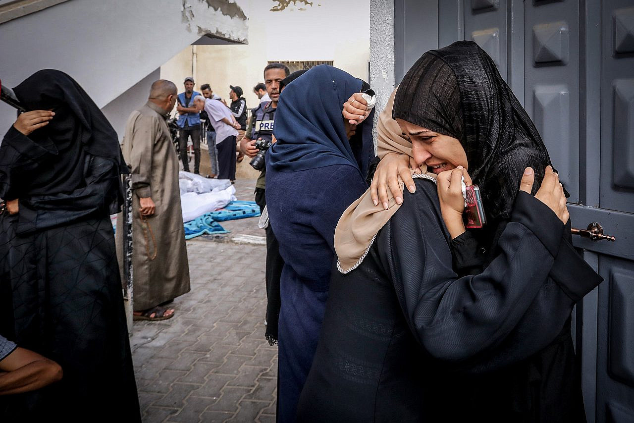 Palestinians wait to receive the bodies of relatives killed in Israeli airstrikes, at Al-Najjar Hospital, in the city of Rafah, southern Gaza Strip, October 24, 2023. (Abed Rahim Khatib/Flash90)