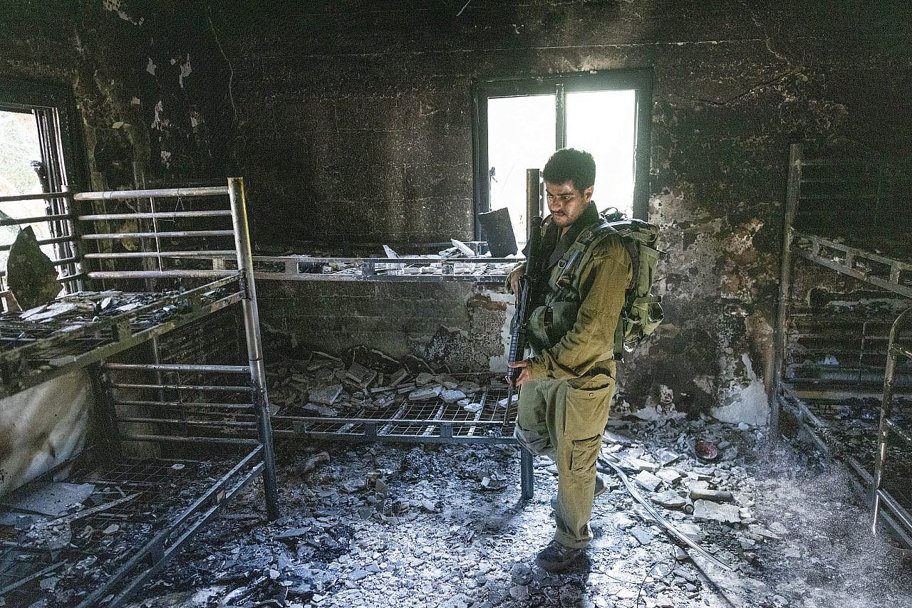 An Israeli soldier inspects the destruction caused by Hamas militants in Kibbutz Nir Oz on Oct. 7, southern Israel, October 30, 2023. (Chaim Goldberg/Flash90)