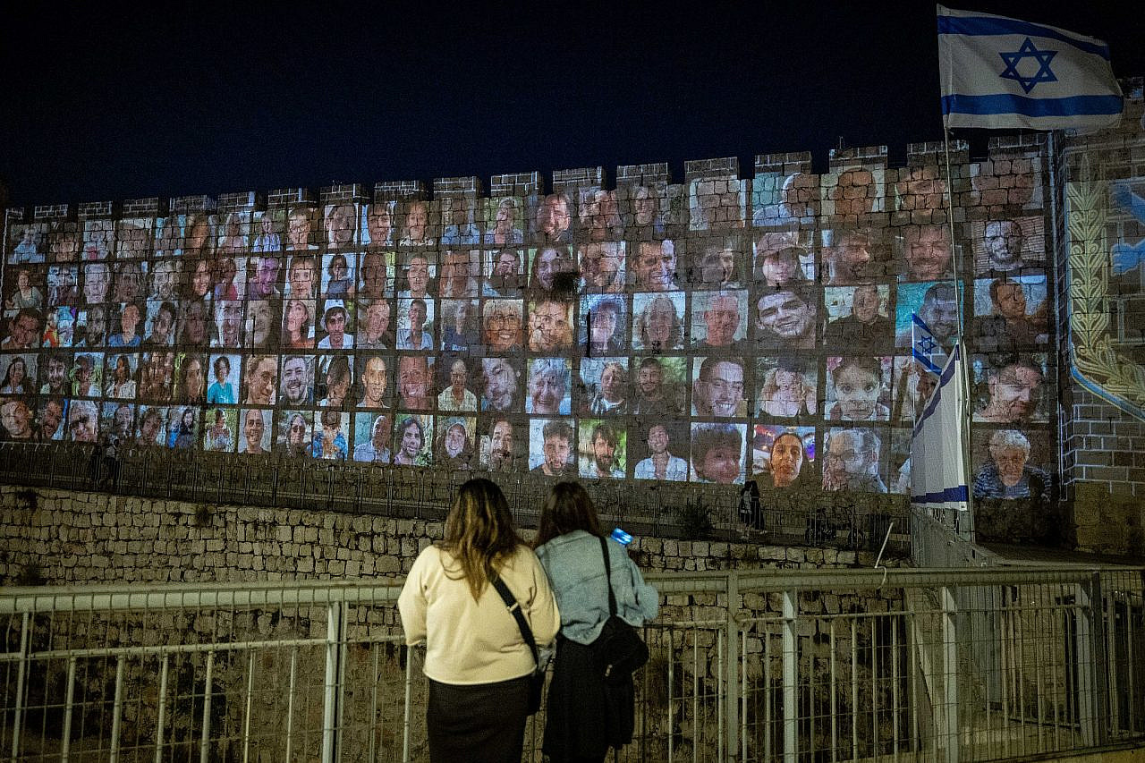 Pictures of Israelis abducted by Hamas in Gaza are projected onto the walls of Jerusalem's Old City, November 6, 2023. (Yonatan Sindel/Flash90)
