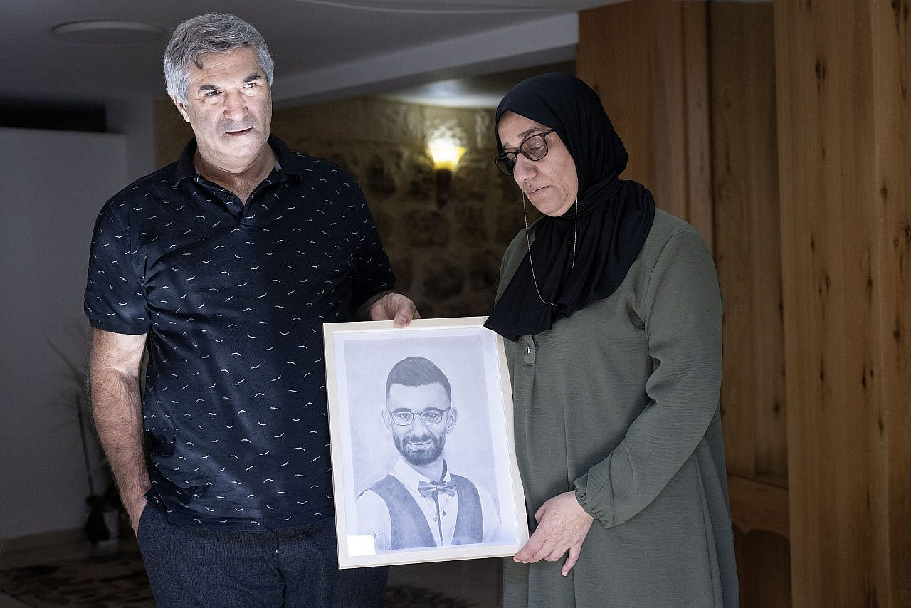 Musa and Huda Darawshe with a photo of their son, Awad. (Oren Ziv)