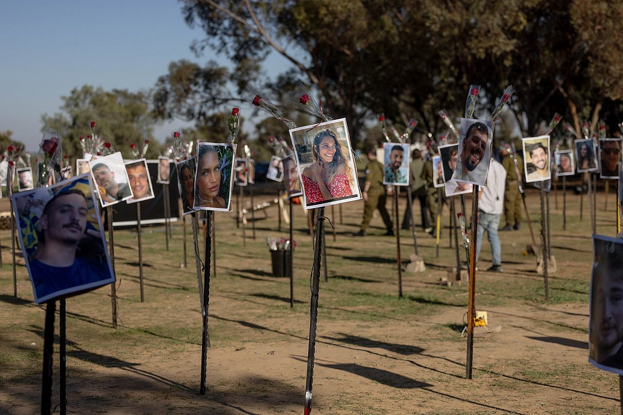 Pictures of the people killed and kidnapped at the Nova music festival on October 7 are displayed at the site of the massacre near the Gaza fence, November 29, 2023. (Chaim Goldberg/Flash90)