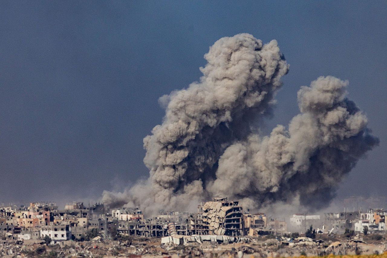 Smoke rises after Israeli airstrikes in the Gaza Strip, as seen from the Israeli side of the fence, December 11, 2023. (Chaim Goldberg/Flash90)