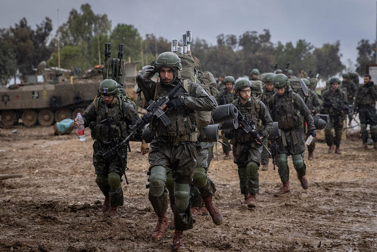 Israeli soldiers seen at a military staging area before entering the Gaza Strip, December 13, 2023. (Chaim Goldberg/Flash90)