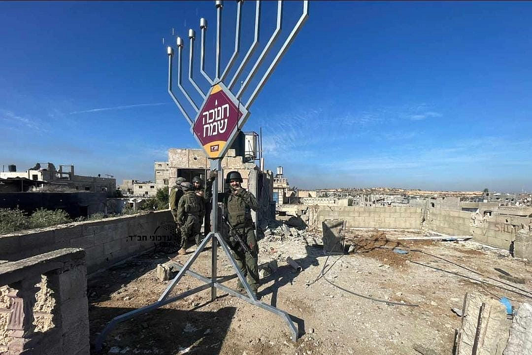 Israeli soldiers erect a hanukkiah on a rooftop in Gaza. (X/Yinon Magal)