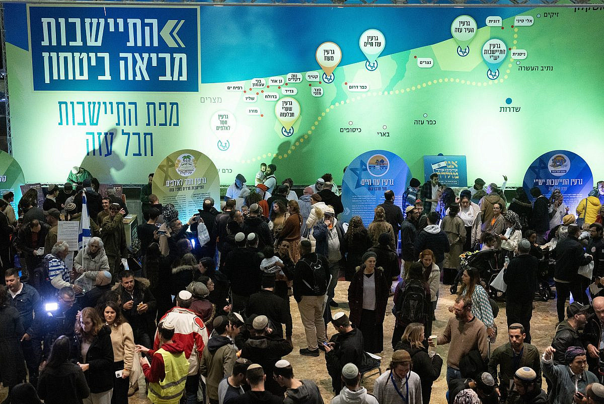 Israelis look at a giant map of the Gaza Strip depicting future Israeli settlements at the "Conference for Israel's Victory" in Jerusalem, January 28, 2024. (Oren Ziv)