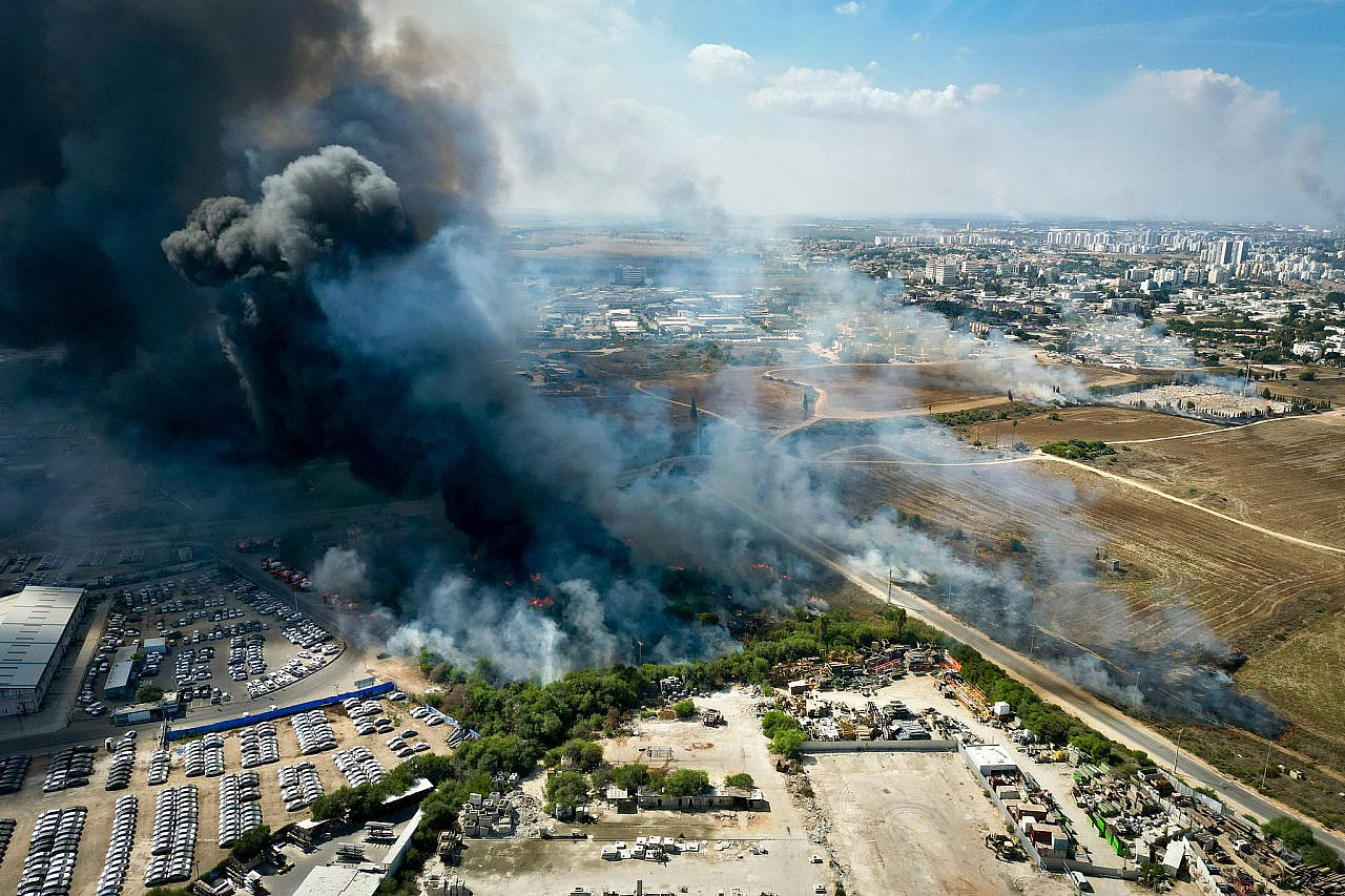 Smoke rises after a rocket fired from Gaza caused damaged in the southern Israeli city of Ashkelon, October 7, 2023. (Erik Marmor/Flash90)