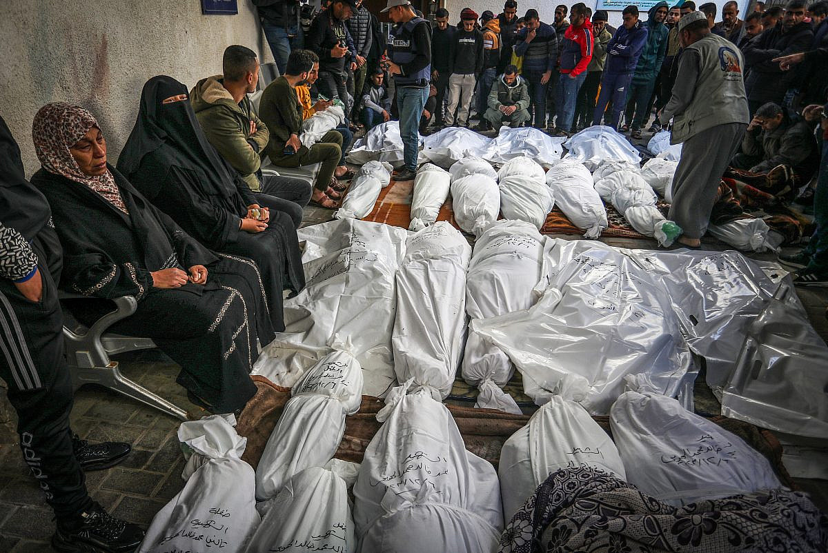 Palestinians wait to receive the bodies of their relatives who were killed in an Israeli airstrike, at Al-Najjar Hospital, southern Gaza Strip, December 7, 2023. (Abed Rahim Khatib/Flash90)
