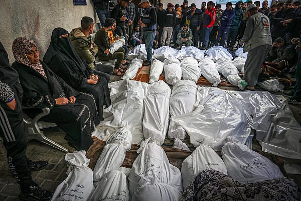 Palestinians wait to receive the bodies of their relatives who were killed in an Israeli airstrike, at Al-Najjar Hospital, southern Gaza Strip, December 7, 2023. (Abed Rahim Khatib/Flash90)