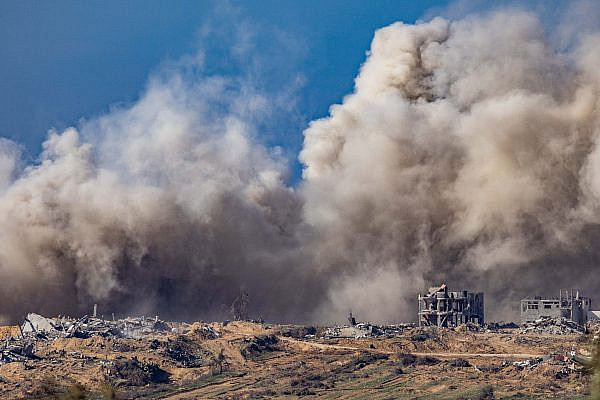 Smoke rises after an Israeli airstrike in the Gaza Strip, as seen from the Israeli side of the fence, January 7, 2024. (Chaim Goldberg/Flash90)