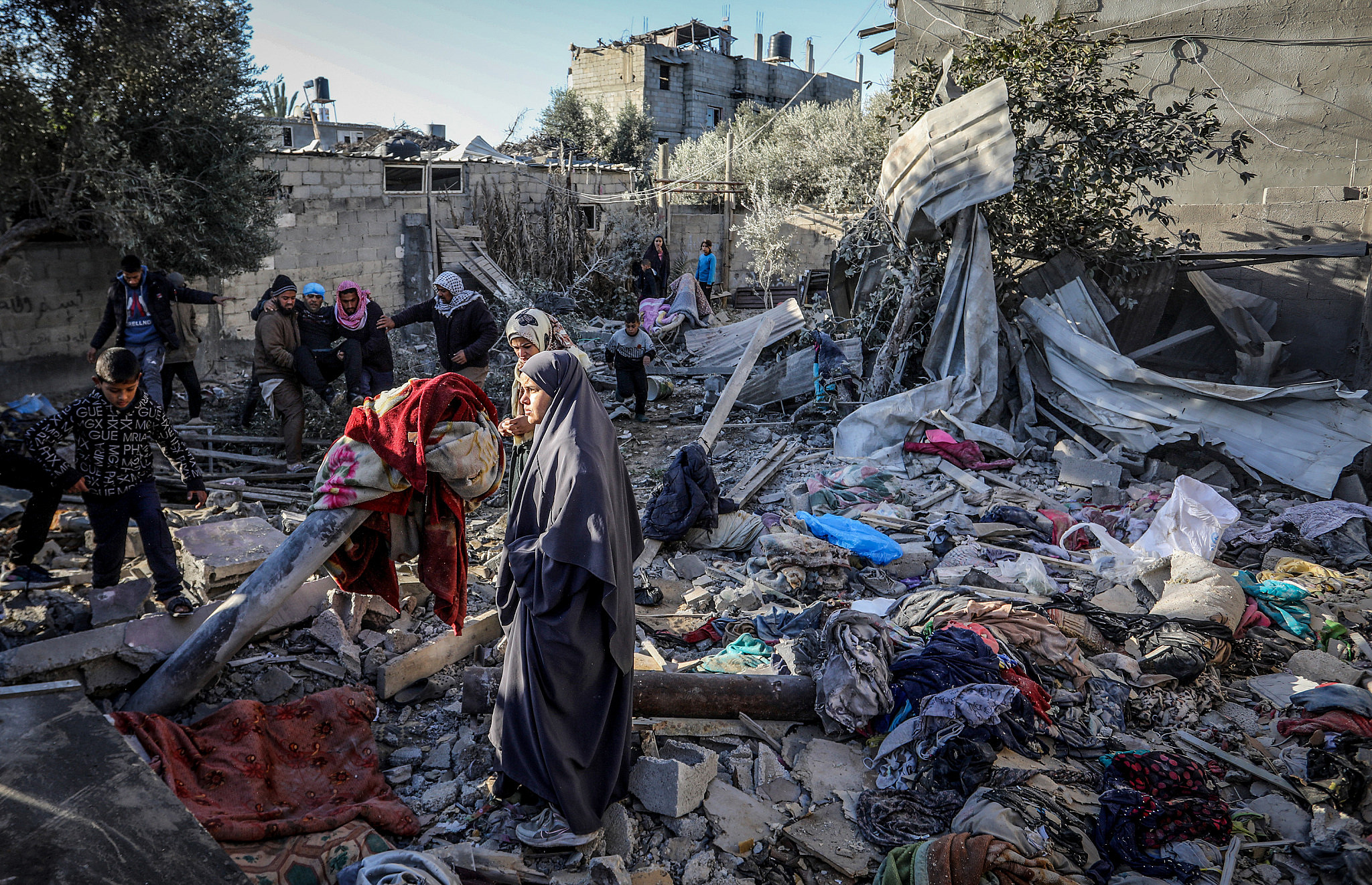 Palestinians at the site of a destroyed house after an Israeli air strike in Rafah, in the southern Gaza Strip, January 18, 2024. (Abed Rahim Khatib/Flash90)