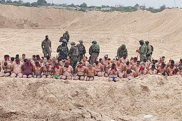 Palestinian men detained by Israeli forces in Beit Lahiya, in the northern Gaza Strip, are moved to areas near the beach, December 7, 2023. (Social media; used in accordance with Clause 27a of the Copyright Law)