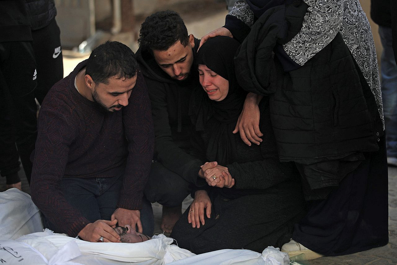 Palestinians mourn their loved ones killed earlier in an Israeli airstrike in Rafah at Al-Najjar Hospital, southern Gaza Strip, December 12, 2023. (Mohammed Zaanoun)