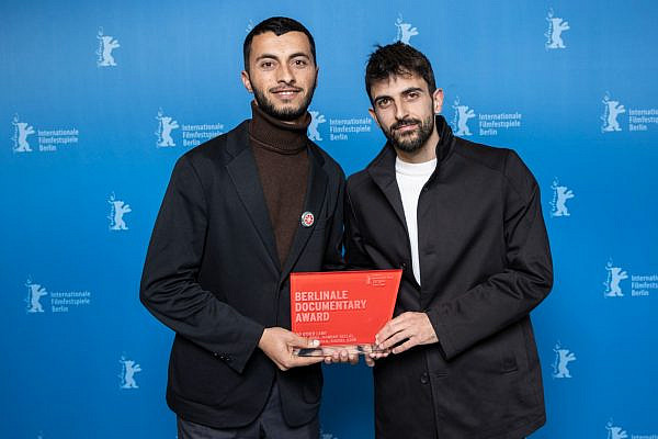 Basel Adra and Yuval Abraham holding the Best Documentary Award for their film 'No Other Land' at the Berlinale film festival, February 24, 2024 (Ali Ghandtschi/Berlinale 2024)
