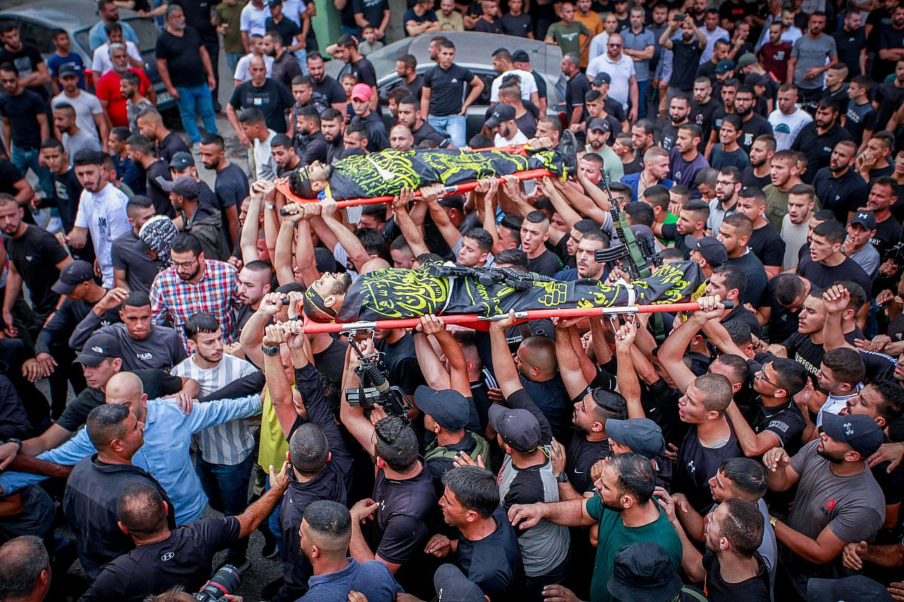 Palestinian mourners and gunmen attend the funeral of two Palestinians who were killed in an Israeli airstrike in Jenin, northern occupied West Bank, October 27, 2023. (Nasser Ishtayeh/Flash90)