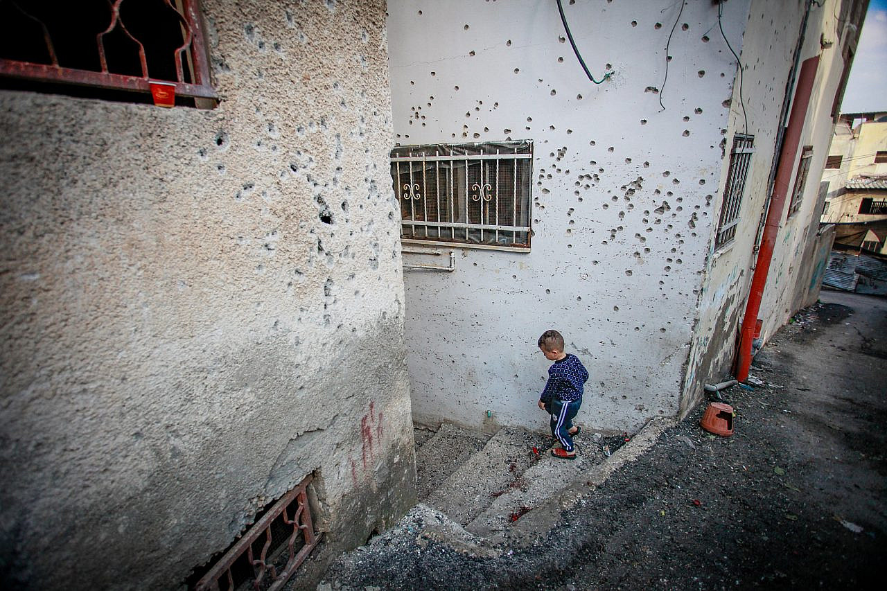 Bullet holes are seen in a wall after a night raid by Israeli forces in the occupied West Bank city of Jenin, November 17, 2023. (Nasser Ishtayeh/Flash90)