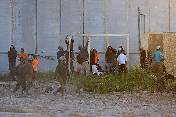 Israeli settlers and right-wing activists seen building an 'outpost' inside Erez Crossing, February 29, 2024. (Oren Ziv)