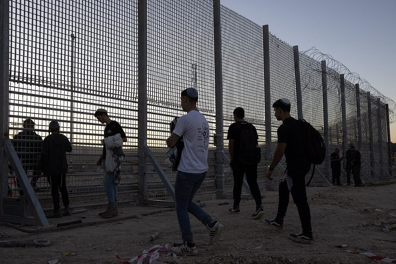 Israeli settlers and right-wing activists cross through a hole in the fence near Erez Crossing, February 29, 2024. (Oren Ziv)