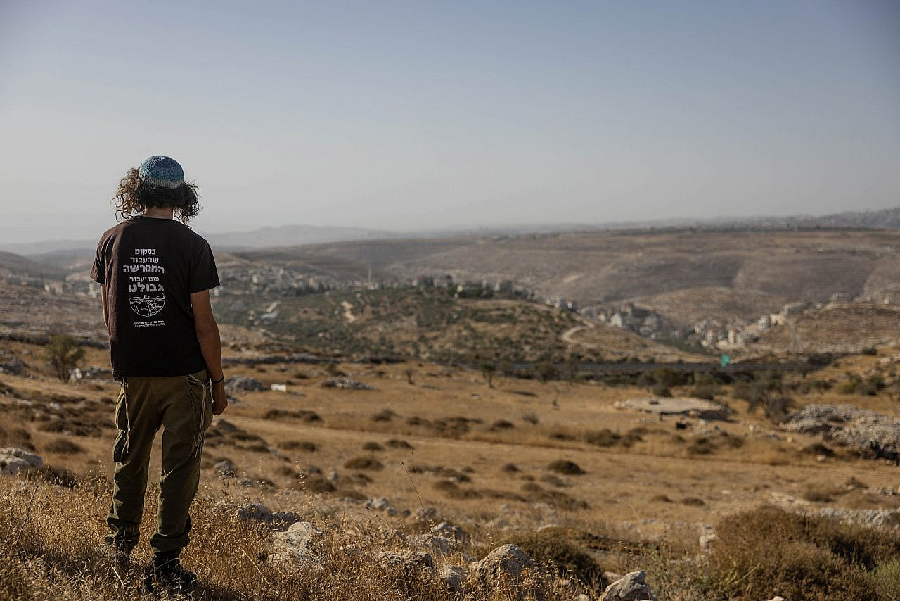 Israeli settlers look out from the outpost of Ramat Migron, occupied West Bank, September 8, 2023. (Chaim Goldberg/Flash90)